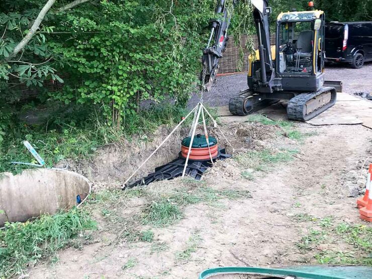 CESS engineers lowering a new Biocel sewage plant into the ground