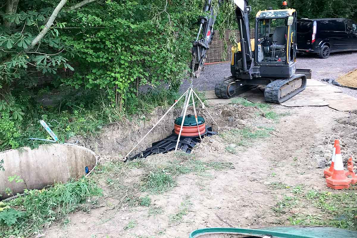 CESS engineers lowering a new Biocel sewage plant into the ground