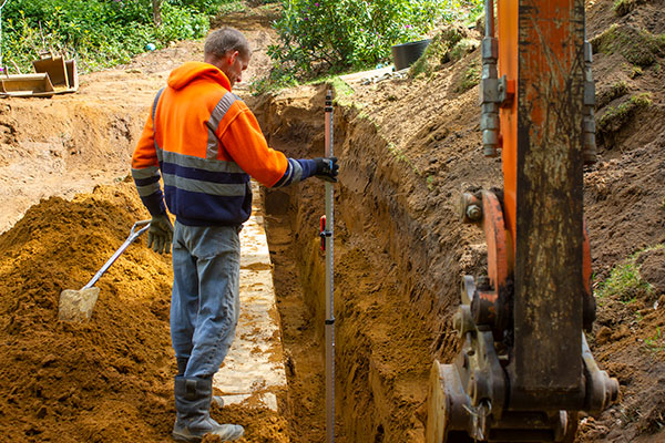 Excavations and checking levels while installing a new drainage field in Liss West Sussex