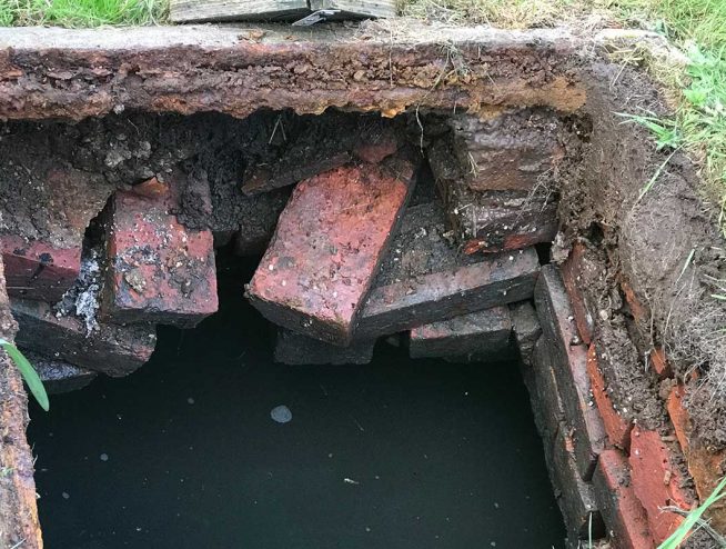 Collapsing brick built septic tank