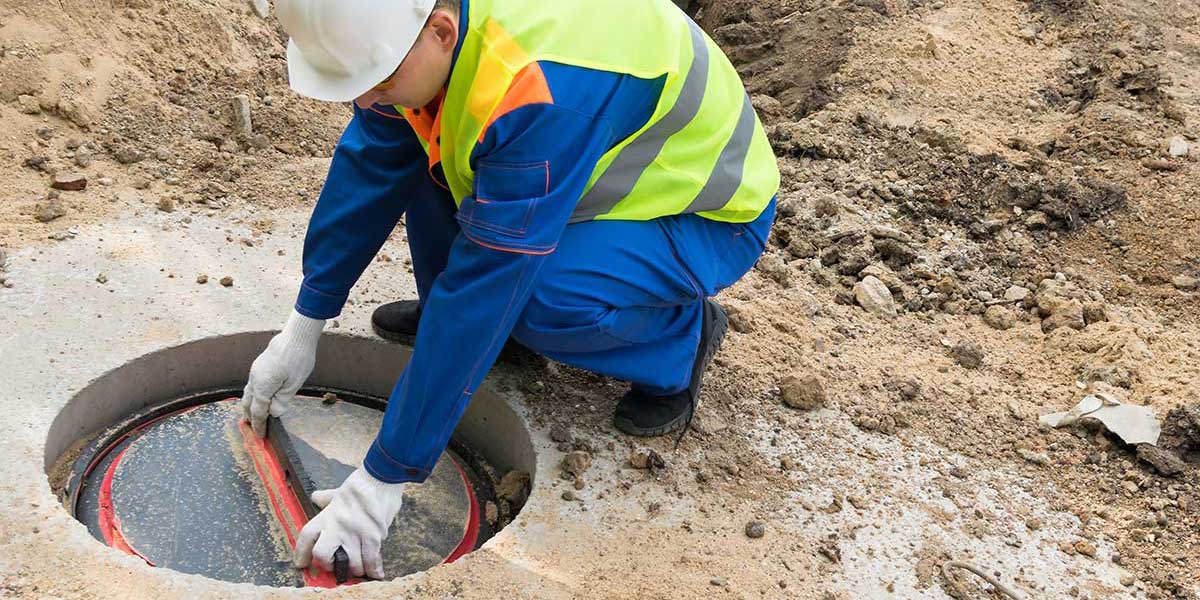 Engineer servicing a sewage treatment plant