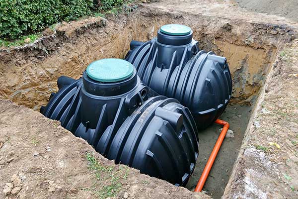 Twin rainwater harvesting tanks being installed underground