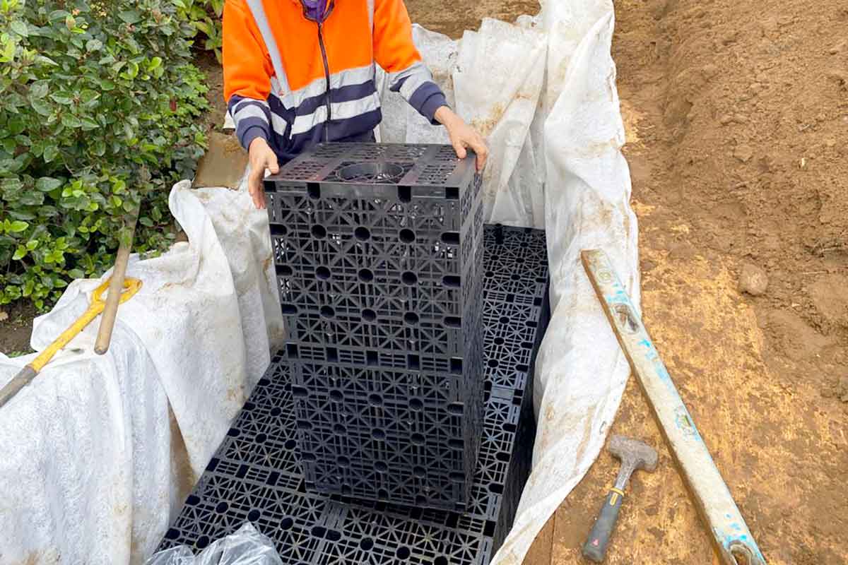 A rainwater soakaway being constructed with soakaway crates